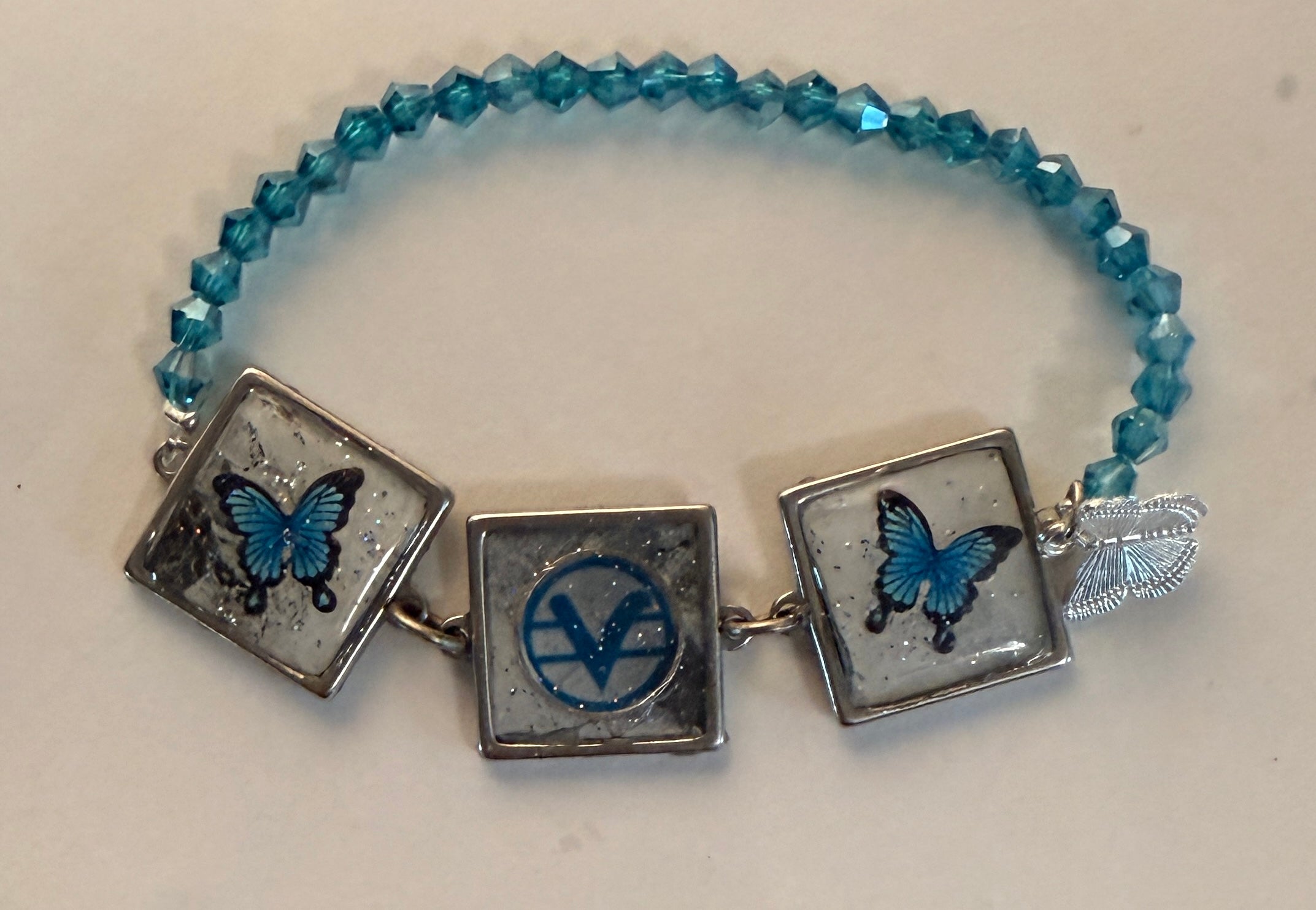 Blue SOM Teaching symbol bracelet with butterflies