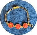 Romantic gold bracelet with red and gold marble background